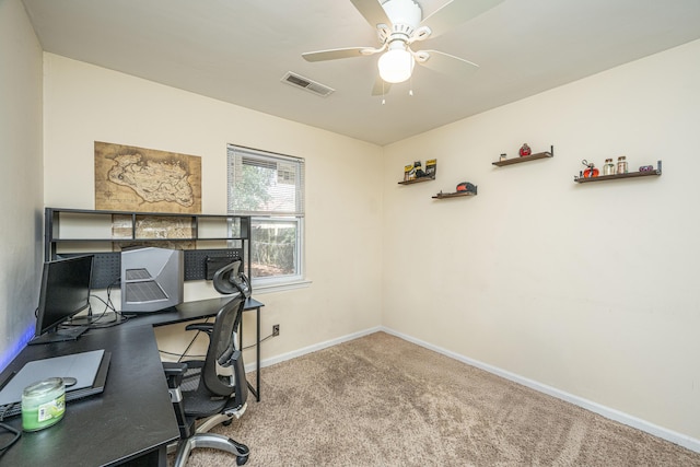 office featuring a ceiling fan, baseboards, visible vents, and carpet flooring