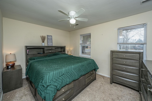 bedroom with a ceiling fan, visible vents, light carpet, and baseboards