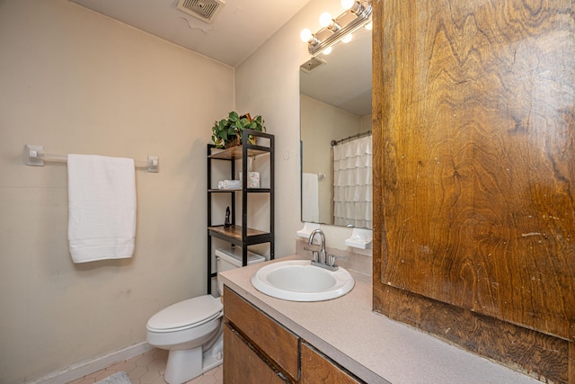 full bathroom featuring toilet, vanity, visible vents, and tile patterned floors