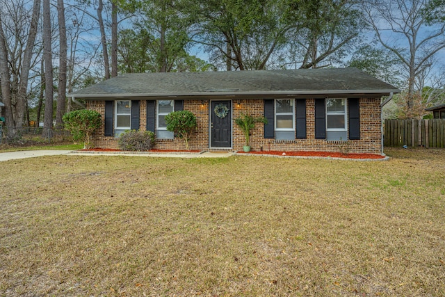 single story home with brick siding, roof with shingles, a front yard, and fence