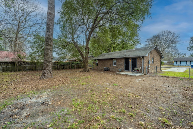 view of yard with a patio area, a fenced backyard, and cooling unit