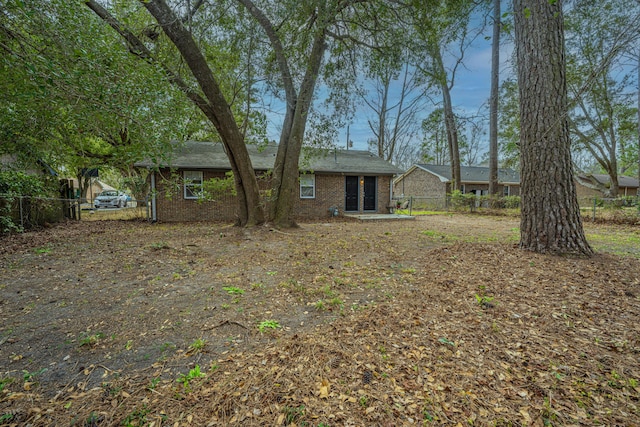 exterior space featuring brick siding and fence