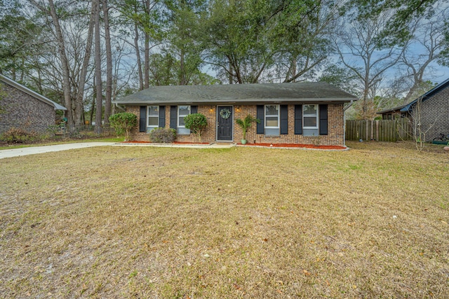 ranch-style home featuring a front lawn, fence, and brick siding