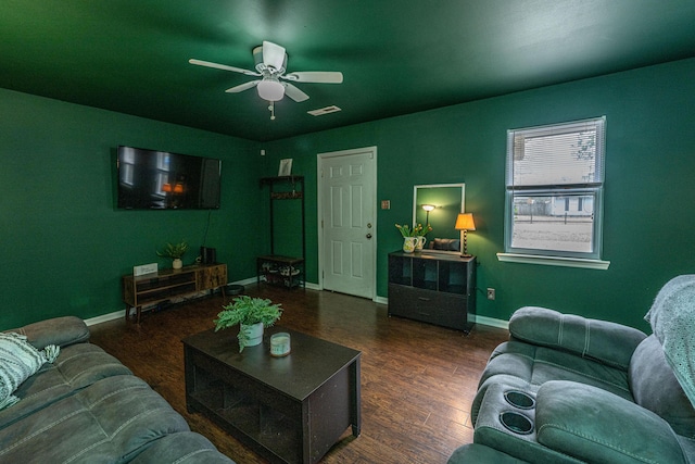 living room with ceiling fan, visible vents, baseboards, and wood finished floors