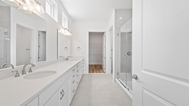bathroom featuring walk in shower and vanity