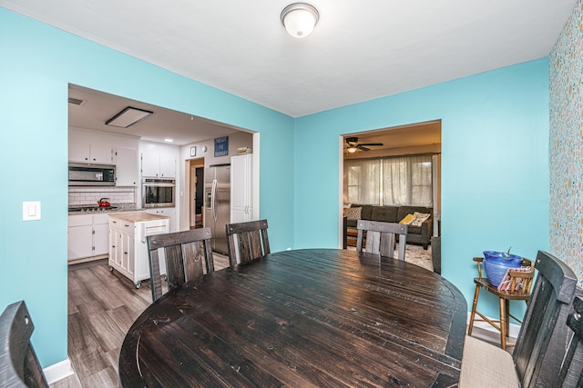 dining space with dark hardwood / wood-style flooring