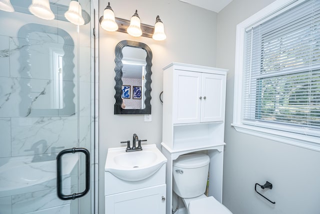 bathroom with vanity, an enclosed shower, and toilet