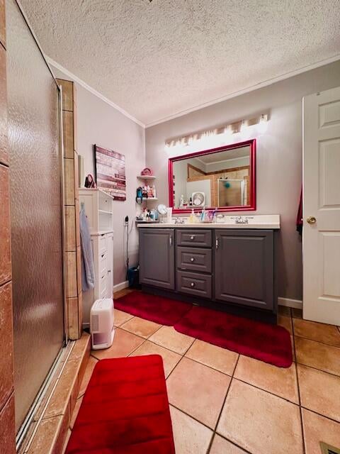 bathroom with an enclosed shower, tile patterned floors, crown molding, vanity, and a textured ceiling