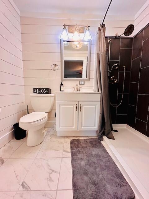 bathroom featuring curtained shower, toilet, wooden walls, and vanity