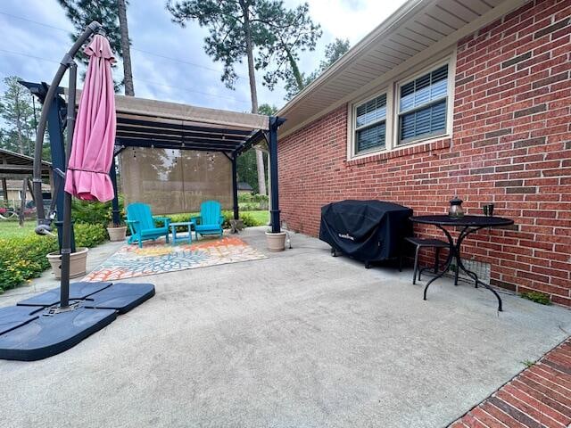 view of patio / terrace with a pergola and a grill