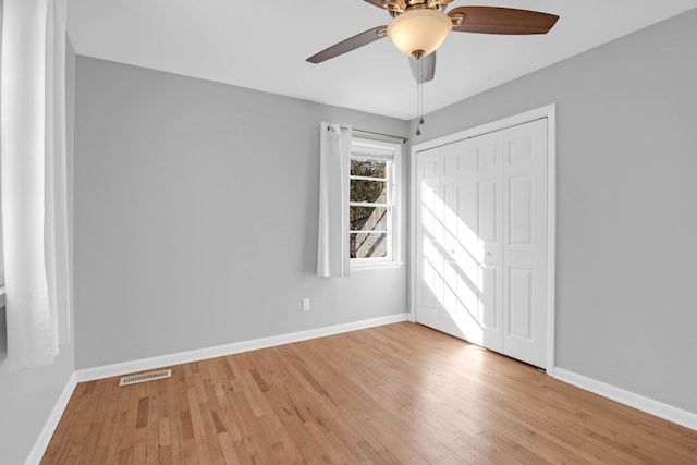 empty room with visible vents, baseboards, and light wood-style flooring