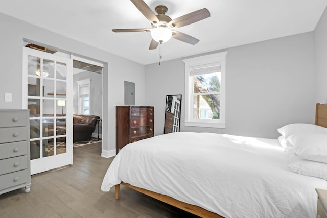 bedroom featuring french doors, wood-type flooring, and a ceiling fan