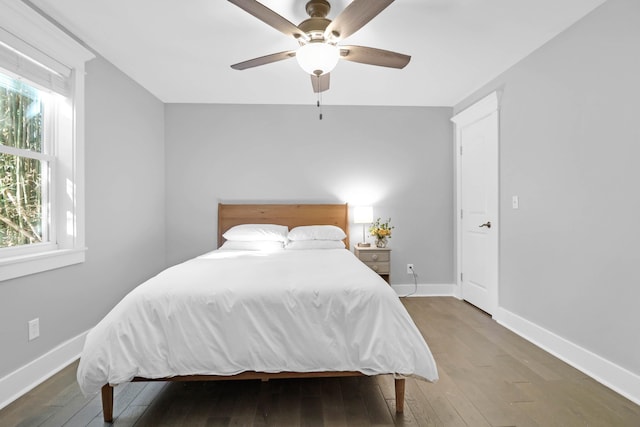 bedroom featuring baseboards, ceiling fan, and hardwood / wood-style flooring