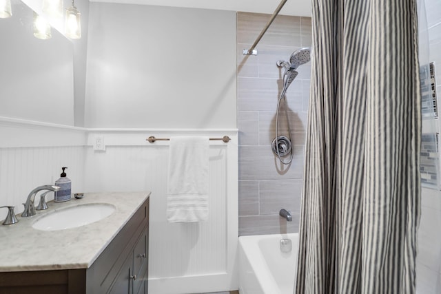 full bath with wainscoting, shower / bath combo, and vanity