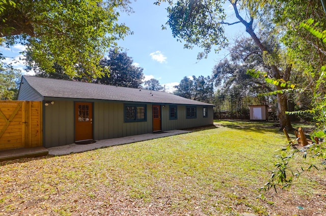 rear view of house with a yard