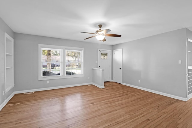 empty room with baseboards and light wood finished floors