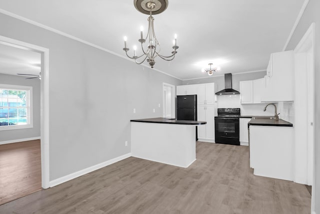 kitchen with black appliances, a sink, dark countertops, crown molding, and wall chimney range hood