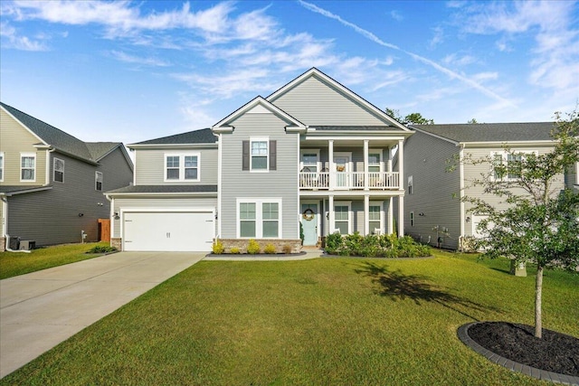 view of front facade with a front yard, a balcony, concrete driveway, and a garage