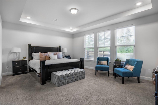 carpeted bedroom with visible vents, recessed lighting, baseboards, and a tray ceiling