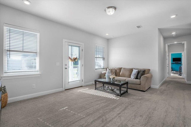 carpeted living room featuring recessed lighting, visible vents, and baseboards