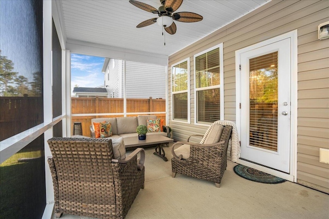 sunroom featuring a ceiling fan