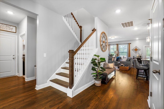 stairway with visible vents, recessed lighting, baseboards, and wood-type flooring