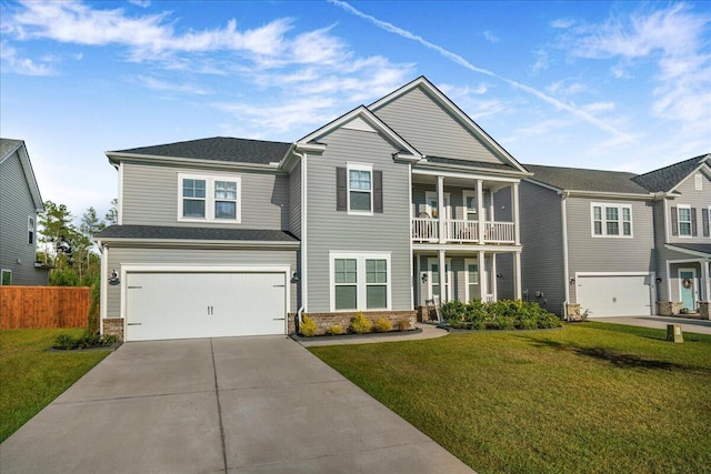 view of front of house featuring a front lawn, an attached garage, stone siding, and driveway