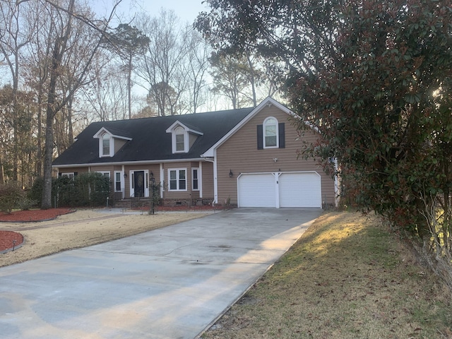 cape cod-style house with crawl space, concrete driveway, and an attached garage