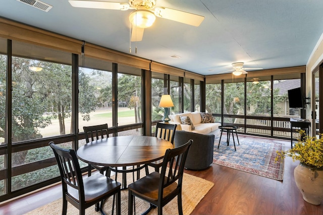 sunroom / solarium with ceiling fan and a healthy amount of sunlight