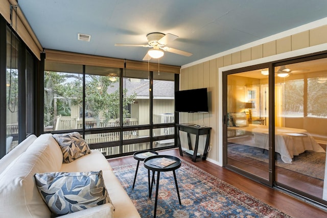 sunroom / solarium featuring ceiling fan