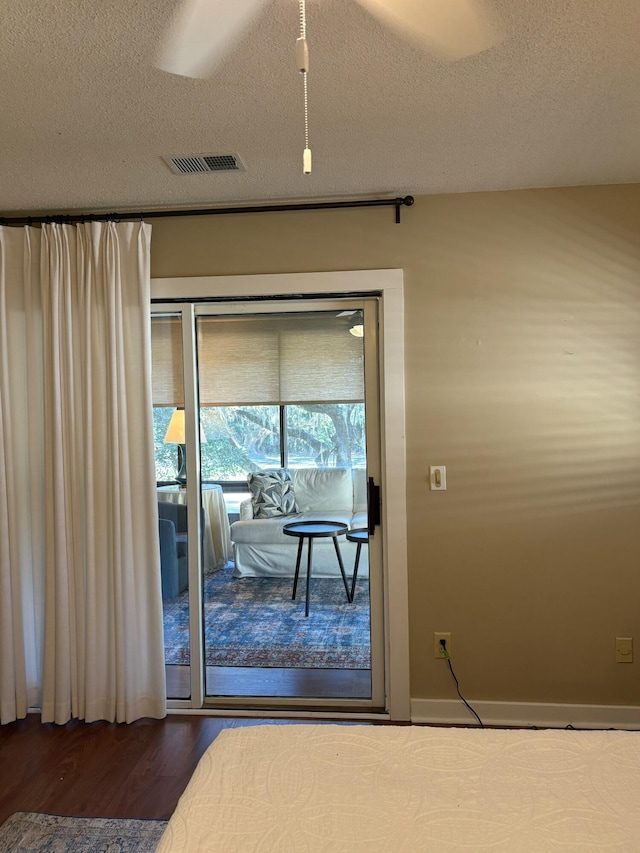 unfurnished bedroom featuring hardwood / wood-style floors and a textured ceiling