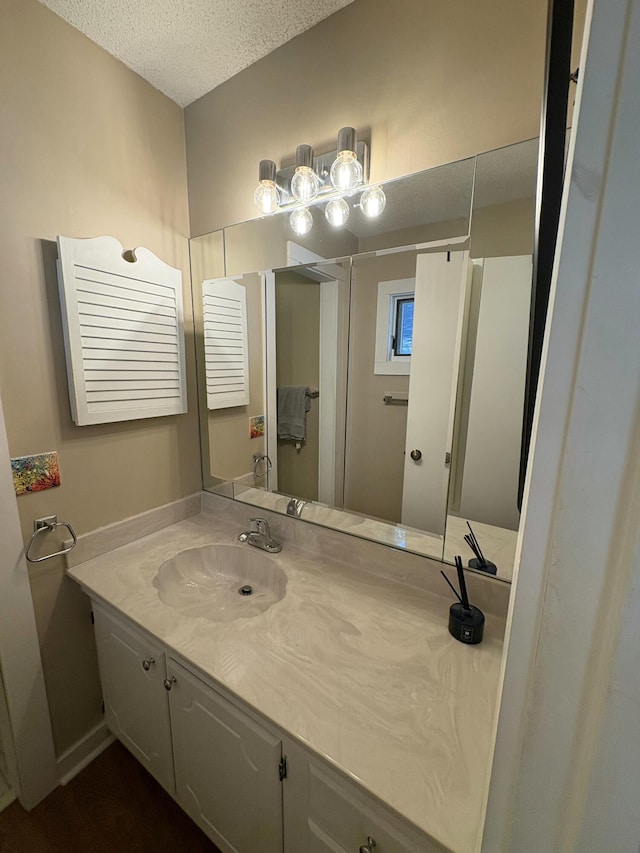 bathroom featuring vanity and a textured ceiling