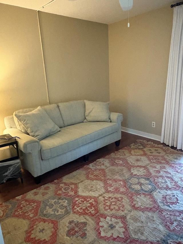 living room featuring hardwood / wood-style flooring and ceiling fan