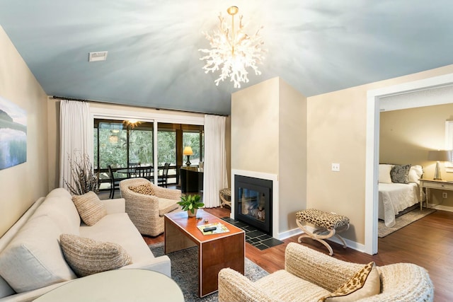 living room featuring a notable chandelier and dark wood-type flooring