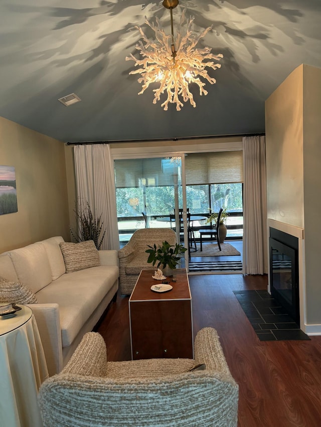 living room with dark hardwood / wood-style flooring and an inviting chandelier