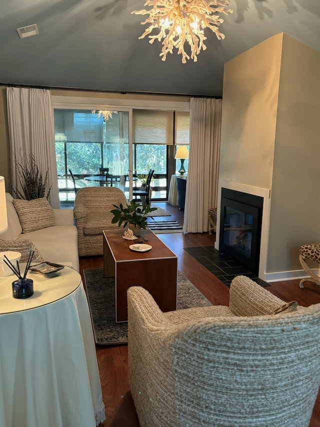 living room featuring a chandelier, plenty of natural light, and dark wood-type flooring