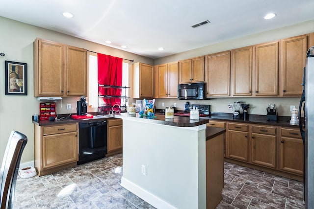 kitchen featuring dark countertops, visible vents, a kitchen island, recessed lighting, and black appliances