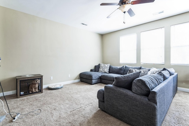 carpeted living room featuring visible vents, ceiling fan, and baseboards