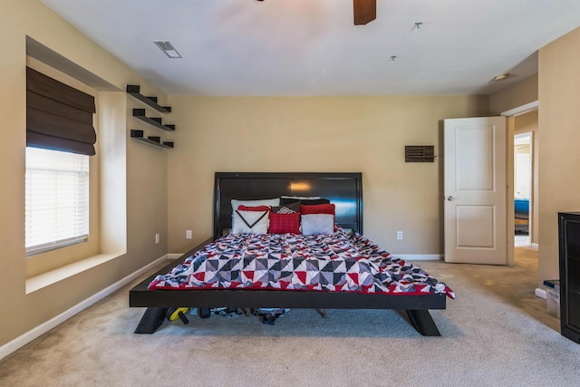 bedroom featuring visible vents, baseboards, carpet, and a ceiling fan