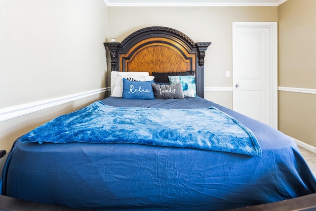 bedroom featuring crown molding, baseboards, and carpet floors