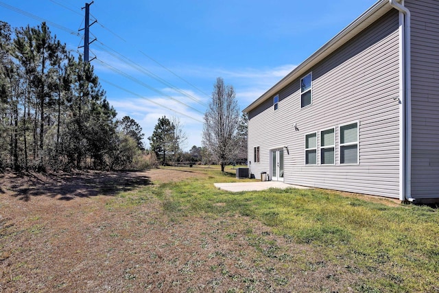 view of yard featuring a patio area and central air condition unit