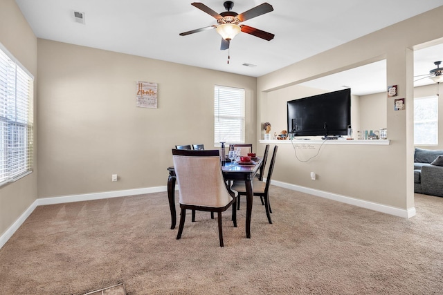 dining area featuring visible vents, carpet, baseboards, and ceiling fan