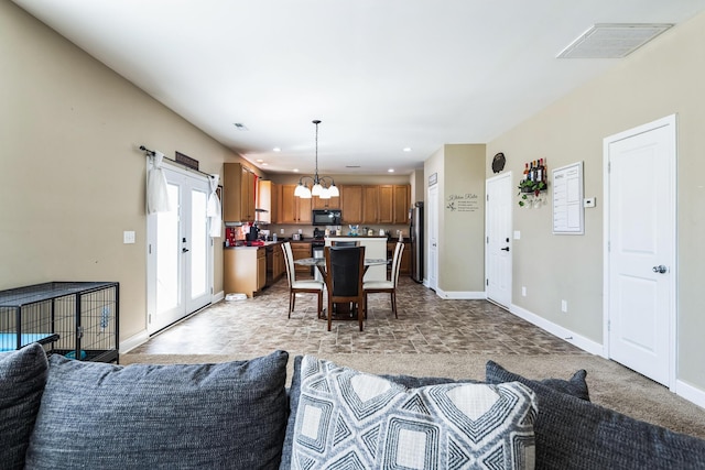 living room with visible vents, recessed lighting, baseboards, and an inviting chandelier