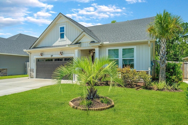 view of front of house with a front yard and a garage