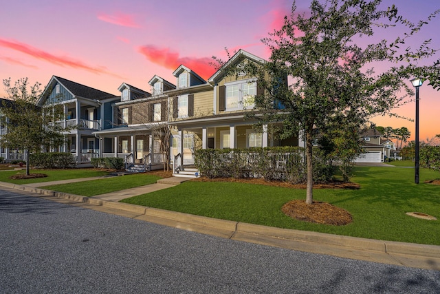 view of front of home featuring a porch and a yard