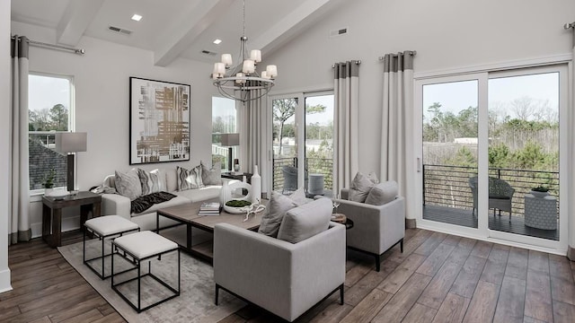 sunroom with a notable chandelier and lofted ceiling with beams