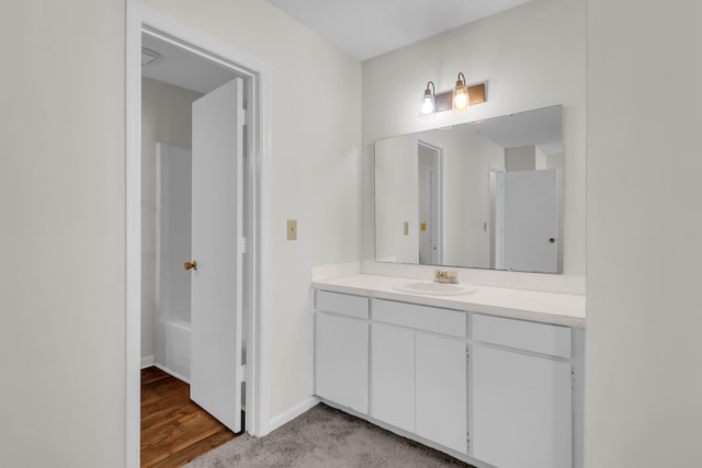 bathroom with vanity, a bathing tub, and hardwood / wood-style flooring