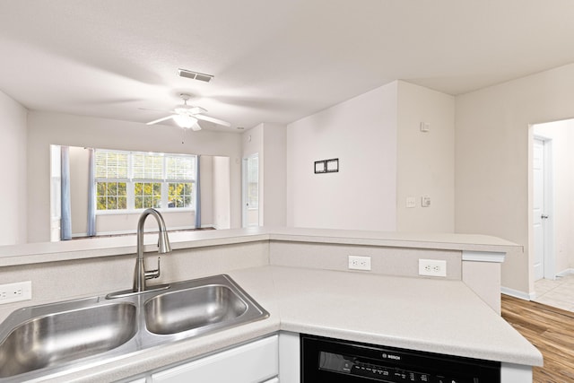 kitchen with ceiling fan, black dishwasher, sink, and light hardwood / wood-style flooring