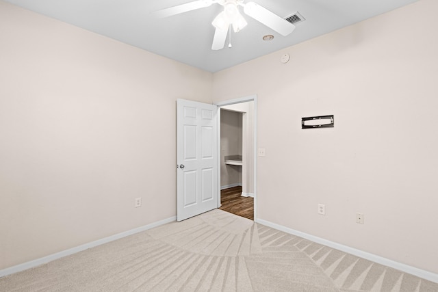 spare room featuring carpet and ceiling fan