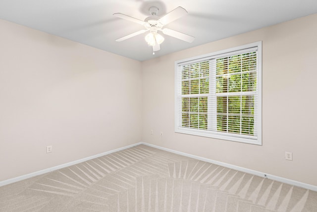 spare room with carpet flooring and ceiling fan